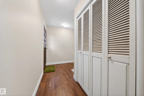 Entryway featuring wood-finish flooring, white baseboards, and neutral wall tones - 34 Grand Meadow Crescent, Edmonton, AB 