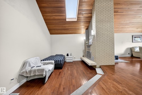 Vaulted wood-finish ceiling with integrated skylight - 34 Grand Meadow Crescent, Edmonton, AB 