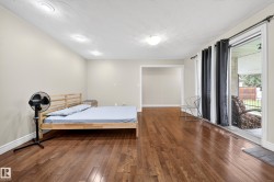 Spacious room featuring rich wood-finish flooring, recessed ceiling lighting, and crown molding - 