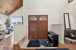 Double entry doors with arched transom windows and a tiled entryway - 
