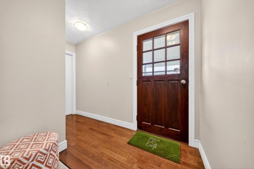 Warm wood-finish flooring provides a welcoming entrance - 34 Grand Meadow Crescent, Edmonton, AB 