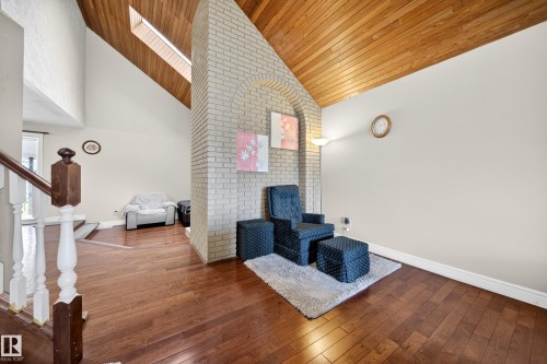 Vaulted wood-paneled ceiling with skylight and light brick architectural element - 34 Grand Meadow Crescent, Edmonton, AB 