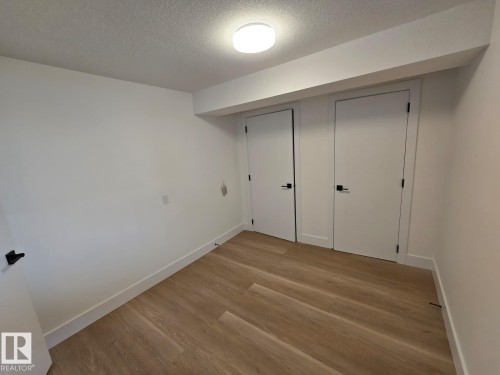 Room featuring light wood-finish flooring, white walls, and bright overhead lighting - 18526 86A Avenue, Edmonton, AB - Indoor Photo Showing Other Room