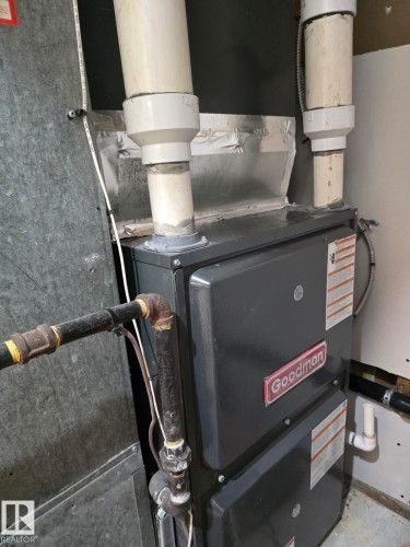 Goodman furnace unit with PVC exhaust piping and gas line connection - 18526 86A Avenue, Edmonton, AB - Indoor Photo Showing Basement