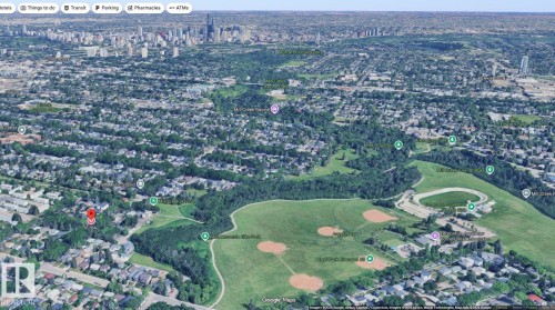 Aerial perspective showcasing a broad urban landscape with varied residential areas and extensive green spaces - 6704 93 Street, Edmonton, AB 