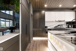 Modern kitchen featuring a wood-finish ceiling with recessed lighting - 