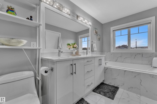 Double vanity with integrated sinks and white cabinetry - 2419 15 Avenue, Edmonton, AB 