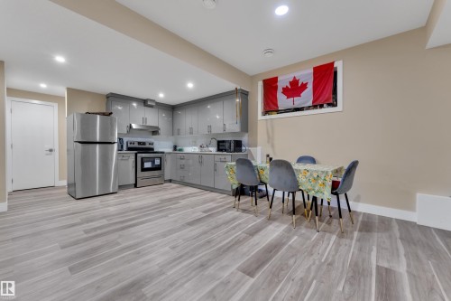 Open-concept living space with wood-finish flooring - 2419 15 Avenue, Edmonton, AB 
