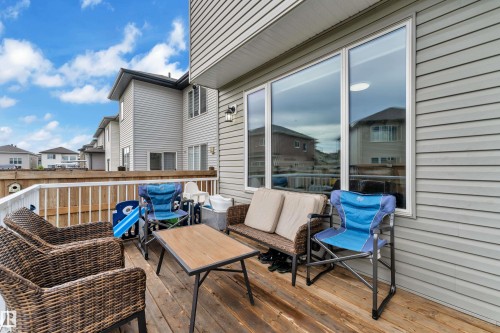 Exterior deck with wood plank flooring and white railing - 2419 15 Avenue, Edmonton, AB 