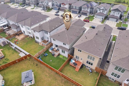 Rear exterior featuring a spacious private yard with wood fencing - 2419 15 Avenue, Edmonton, AB 