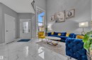 Spacious living area featuring a two-story ceiling, tall windows, and large format tile flooring - 2419 15 Avenue, Edmonton, AB 