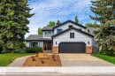 Two-story residence featuring light gray siding, dark trim, and a prominent dark garage door - 5716 175 Street, Edmonton, AB 