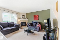 Living area featuring a corner fireplace with a tiled surround and mantel - 