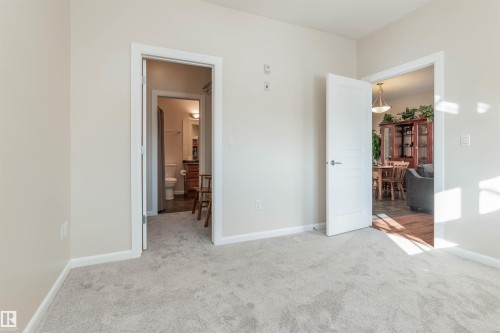 Light-colored carpeting with painted walls and white trim - 439 300 Palisades Way, Sherwood Park, AB - Indoor Photo Showing Other Room