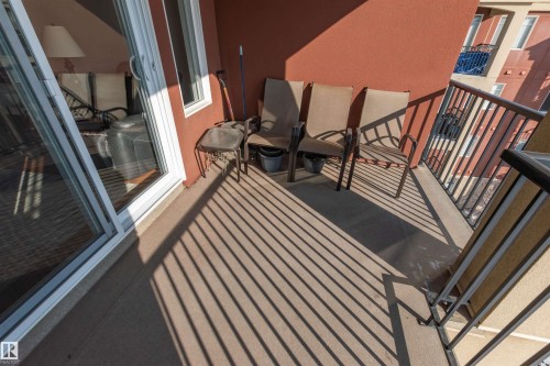 Private balcony featuring a concrete surface, red exterior wall, and black metal railing - 439 300 Palisades Way, Sherwood Park, AB - Outdoor With Balcony With Exterior
