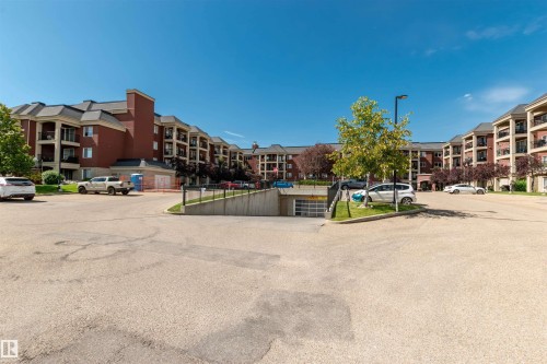Expansive residential complex featuring red brick facades, dark-toned hip roofs, and multiple private balconies - 439 300 Palisades Way, Sherwood Park, AB - Outdoor