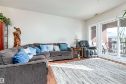 Living area featuring wood-finish flooring and light-toned walls - 