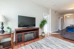 Spacious interior featuring wood-finish flooring, light-colored wall paint, and white trim - 