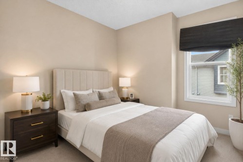 Bedroom featuring neutral wall colors, a single window with a dark fabric shade, and carpet flooring - 30 6075 Schonsee Way, Edmonton, AB 
