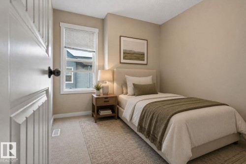Carpeted interior space featuring a single window with blinds, a paneled door with a black knob, and light-toned wall paint - 30 6075 Schonsee Way, Edmonton, AB 