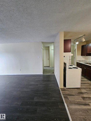 Contemporary wood-finish flooring complements light-toned walls - 401 10615 110 Street, Edmonton, AB 