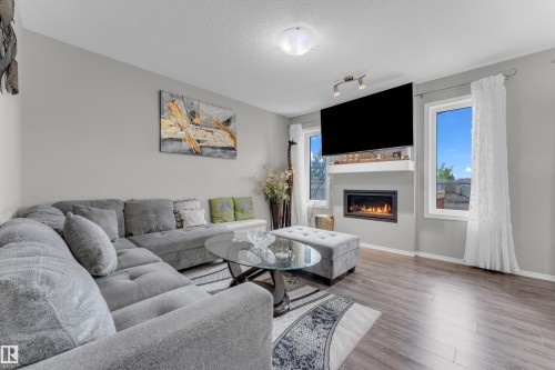 Living area featuring wood-finish flooring and light gray walls - 1532 33B Street, Edmonton, AB 