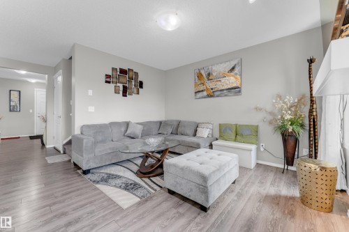 Living area featuring light wood-finish flooring and neutral wall tones - 1532 33B Street, Edmonton, AB 