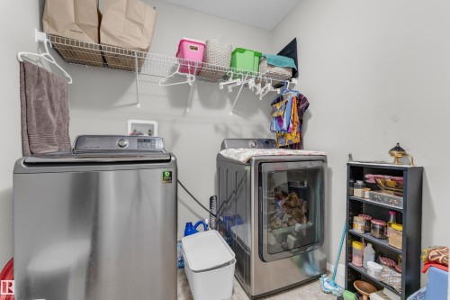 Dedicated laundry area with light gray walls and wire shelving - 1532 33B Street, Edmonton, AB 