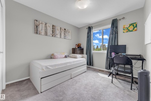 Carpeted room featuring light gray wall paint and a single window with curtain rods - 1532 33B Street, Edmonton, AB 