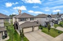 Contemporary two-story residence featuring a two-car garage, concrete driveway, and a combination of siding and stone veneer exterior finishes - 1532 33B Street, Edmonton, AB 