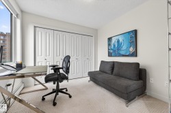 Interior room featuring light-toned carpeting, white walls, and a large window providing natural illumination - 