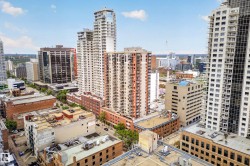 Urban landscape featuring diverse architectural styles, including modern high-rise buildings and classic brick structures - 