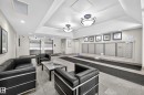 Building entrance featuring a tiled floor, recessed lighting, and two stainless steel elevators - 1701 10180 104 Street, Edmonton, AB 