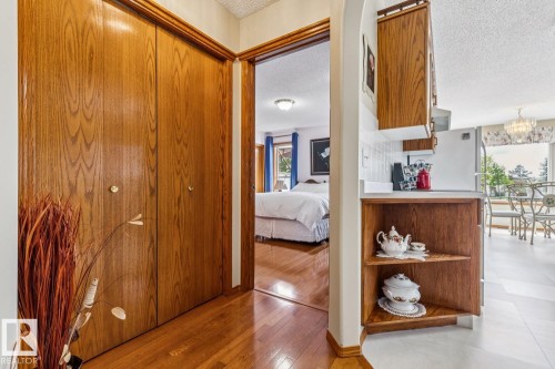 Hardwood flooring extending from the entryway into an adjoining room - 5131 152A Avenue, Edmonton, AB 