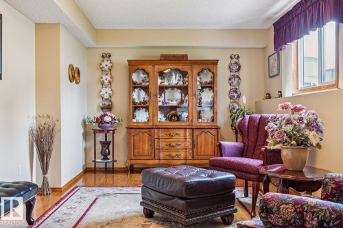 Light-toned walls with a tray ceiling detail and wood-finish flooring - 5131 152A Avenue, Edmonton, AB 
