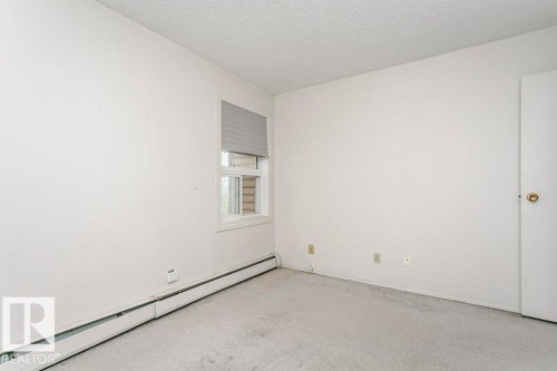 Room featuring light gray carpeting, a window with horizontal blinds, and a white interior door - 71 11255 31 Avenue, Edmonton, AB - Indoor Photo Showing Other Room