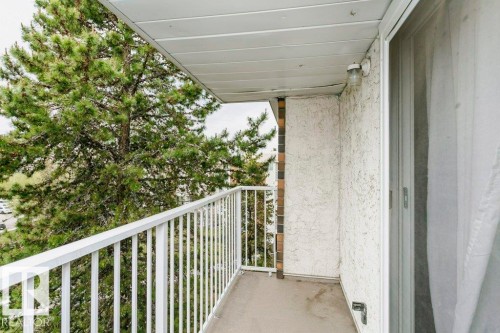 Private balcony featuring a concrete floor, white metal railing, and textured exterior wall - 71 11255 31 Avenue, Edmonton, AB - Outdoor With Exterior