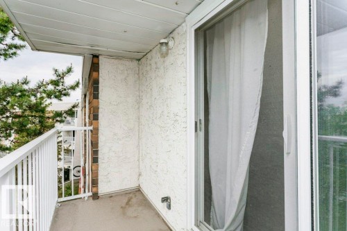 Private balcony featuring a concrete floor, white metal railing, and textured stucco exterior - 71 11255 31 Avenue, Edmonton, AB - Outdoor With Exterior