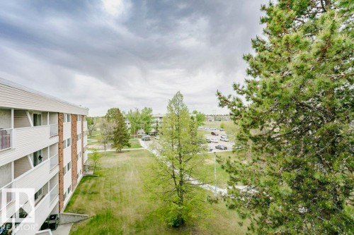 Multi-story building featuring white horizontal siding and brick accents - 71 11255 31 Avenue, Edmonton, AB - Outdoor