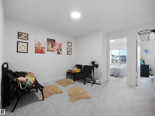 Carpeted room with white walls and a ceiling-mounted light fixture - 19316 29 Avenue, Edmonton, AB 