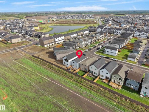 Aerial perspective showcasing a residential development with a prominent detention pond - 19316 29 Avenue, Edmonton, AB 