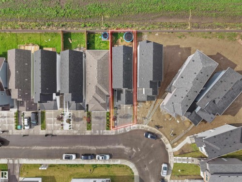 Aerial view highlighting a residential property with a compact backyard, a paved driveway, and a shingled roof - 19316 29 Avenue, Edmonton, AB 