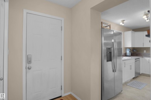 Entryway featuring a paneled door with smart lock hardware - 292 Simmonds Way, Leduc, AB 