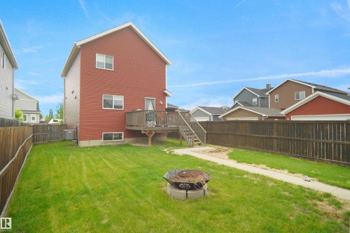 Two-story residence with red siding and white trim - 292 Simmonds Way, Leduc, AB 