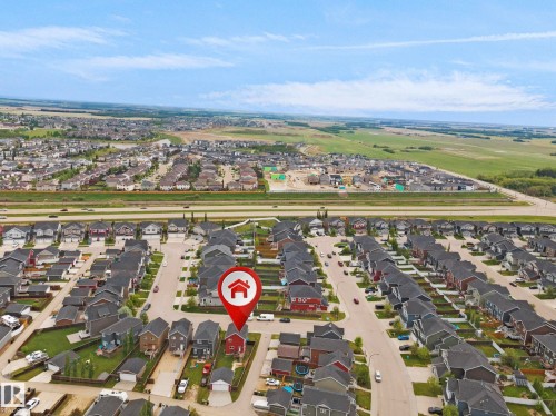 Aerial perspective showcasing a residential neighborhood with detached homes and a clear sky - 292 Simmonds Way, Leduc, AB 