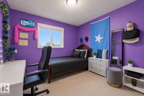 Spacious room featuring broadloom carpeting, a double-pane window, and a built-in overhead light fixture - 1804 121 Street, Edmonton, AB 