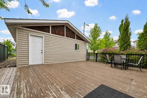 Expansive wood deck with a detached utility building featuring horizontal siding and decorative shingle accents - 1804 121 Street, Edmonton, AB 