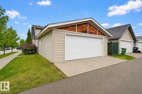 Detached two-car garage with a white panel door and a concrete driveway - 1804 121 Street, Edmonton, AB 