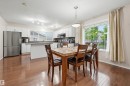 Open-concept kitchen and dining area featuring wood-finish flooring - 1804 121 Street, Edmonton, AB 