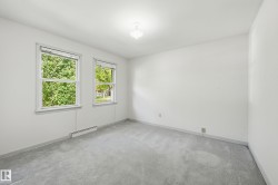 Primary bedroom off front of house with closet and windows to bring in natural light - 